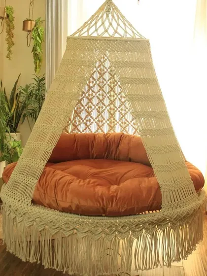 Our largest bed sofa swing is designed for deep sleep and relaxation. The off-white macrame paired with a warm orange mattress creates a cozy and inviting space.