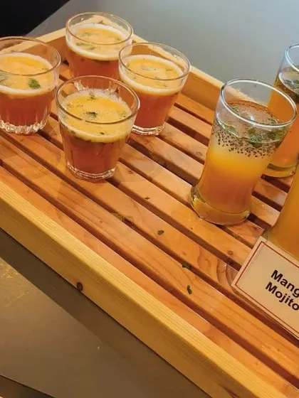 Our beverage menu includes creative options like Mango Mojito and Fruit Punch. We serve them in stylish glassware on wooden trays for a rustic-chic presentation.