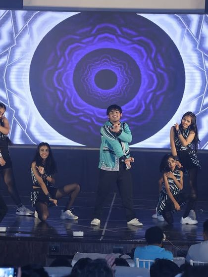 A synchronized moment from the Bollyhop performance, set against a cool graphic backdrop that enhances the modern vibe of the act.