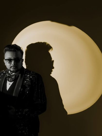 An artistic portrait of the groom, using creative lighting to cast an interesting shadow.