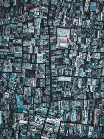 A bird's eye view of the dense urban fabric of Dahod, Gujarat. The top-down perspective reveals the intricate patterns and geometry of the city.