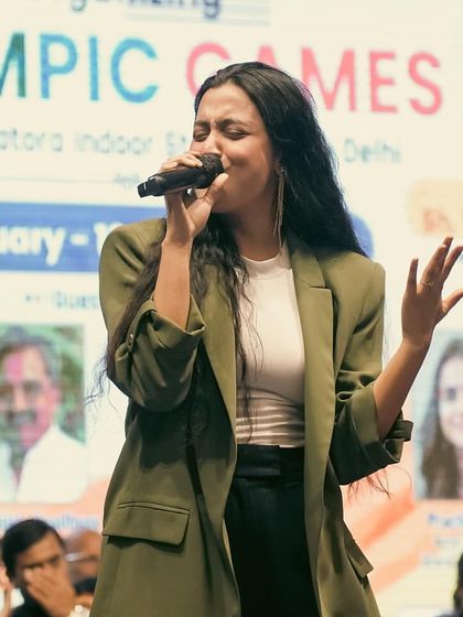 Singing with passion at the Delhi Olympic Games 2024. This image captures the intensity and emotion I bring to every song.