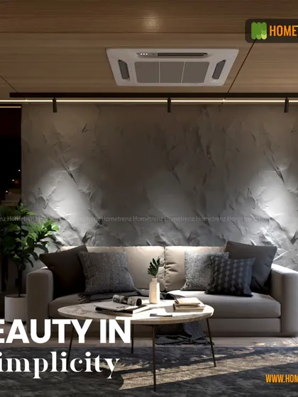 I find beauty in simplicity. This living room uses a textured concrete-finish wall, a simple grey sofa, and focused track lighting to create a minimalist yet warm and inviting atmosphere.