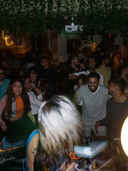 A view from behind my shoulder, looking out at a happy, dancing crowd.