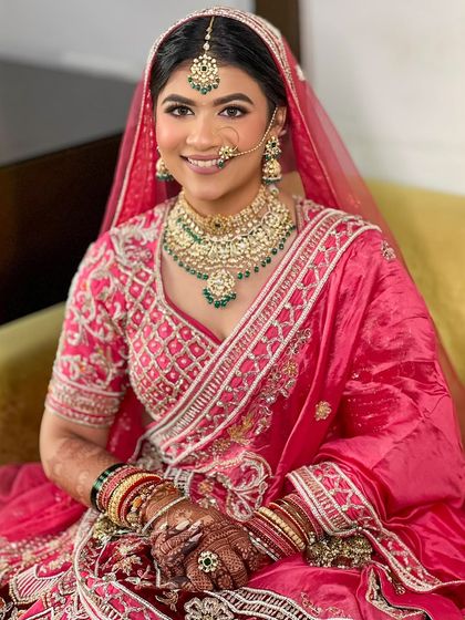 A portrait of the happy bride, showcasing her flawless makeup and traditional hairstyle.