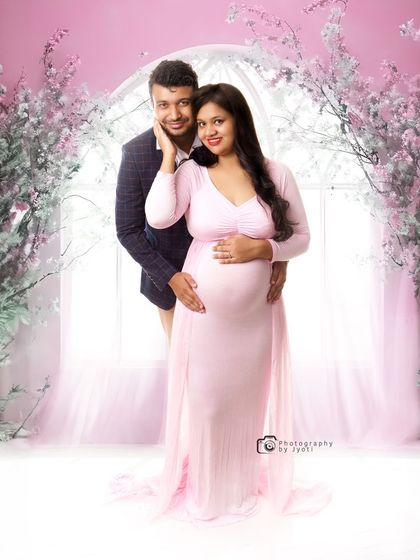 A lovely couple's portrait in a dreamy pink floral setting. This setup is perfect for a romantic and soft-themed maternity shoot in my Gurgaon studio.