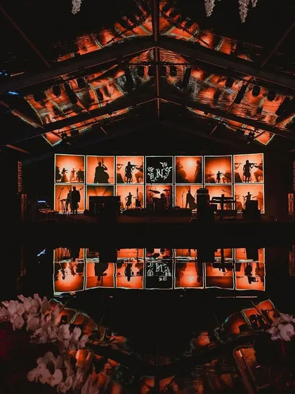 The DJ console at a poker-themed cocktail night, with a custom LED screen backdrop. We integrate technology and branding into our event designs for a cohesive look.