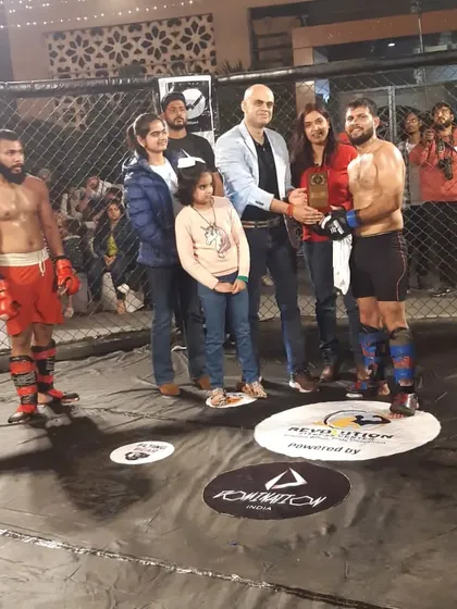 Our fighter receiving his trophy after a win in Bareilly. A proud moment for him and the club.