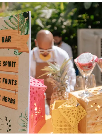 A DIY bar at a pool party, where guests can choose their own spirits, fruits, and herbs to create custom cocktails.
