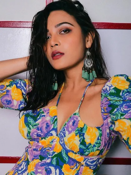 Another angle of the wet-look hair and makeup on Kaveri Priyam. This style is about creating texture and shine, resulting in a modern and edgy editorial look.