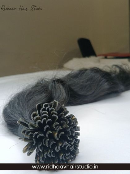 A close-up of our U-Tip wavy hair extensions, showcasing the keratin tips ready for heat-bonded application.