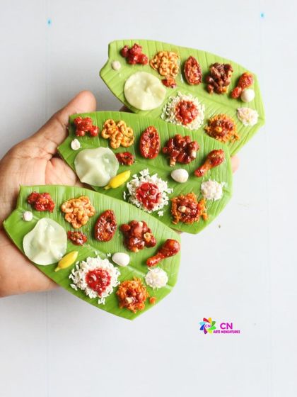 A collection of non-veg leaf meal magnets, featuring dishes like chicken 65 and fish curry.
