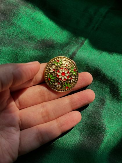 A beautiful floral Meenakari ring with red, green, and white enamel work. This piece is like a small painting for your finger.