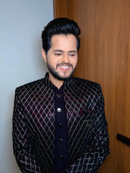 A stylish quilted jacket for a Sangeet or cocktail party. The hair is styled with a modern quiff, and the makeup is sharp and defined.