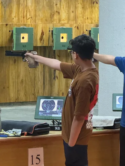 A young para-athlete receiving guidance on his shooting technique. I am committed to providing adaptive coaching to help every shooter reach their full potential, regardless of physical ability.