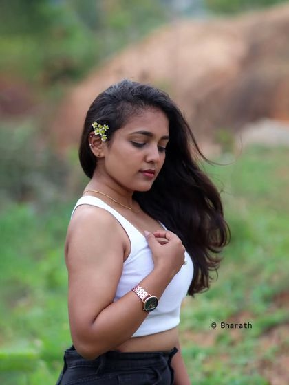 Capturing a gentle, thoughtful moment outdoors. The soft focus on the background helps the subject stand out.