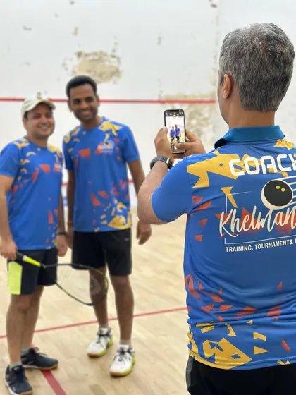A coach's job isn't just to instruct, but also to capture the memories. Snapping a photo of our players after a great match.