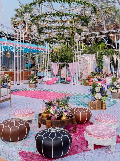 Another view of the 'Botanical Marrakesh' mehendi, with its colorful rugs and Moroccan-style poufs. The design was a feast for the senses, blending textures, colors, and patterns to create a vibrant and welcoming space.