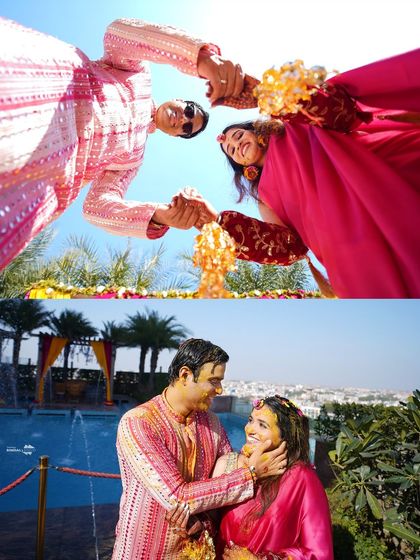 A creative, low-angle shot of the couple during their Haldi. This unique perspective, looking up at the sky, creates a dramatic and memorable image.