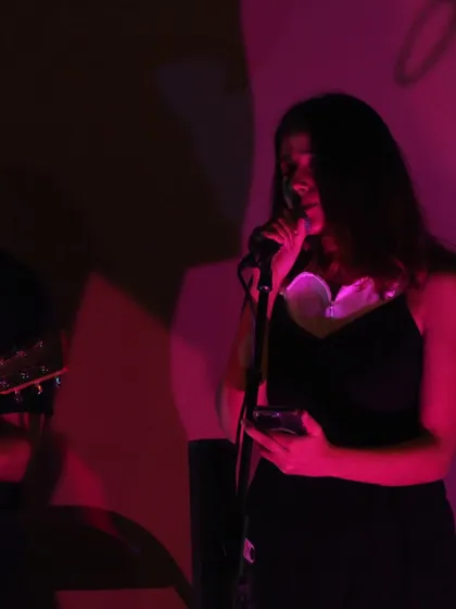 Lost in the song under the pink lights. These intimate shows feel like sharing secrets with the audience.