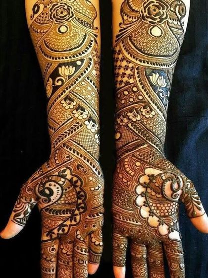 An example of our dense, intricate bridal work. This design features a mix of paisleys, lotuses, and geometric patterns, creating a rich and luxurious look.