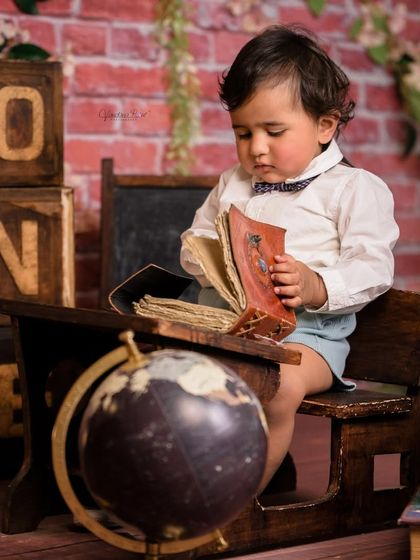 A gallery of our popular school and library theme. These images show the versatility of the brick wall backdrop, mini school desk, globe, and book props for creating a variety of scholarly and classic portraits.