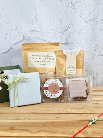 An elegant Rakhi gift set featuring our handmade treats like Coffee Cookies and Almond & Milk Chocolate Florentine, ready to be sent with love.