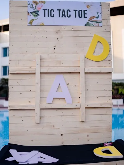 A giant, personalized tic-tac-toe game using the couple's initials, adding a fun and interactive element to the event.
