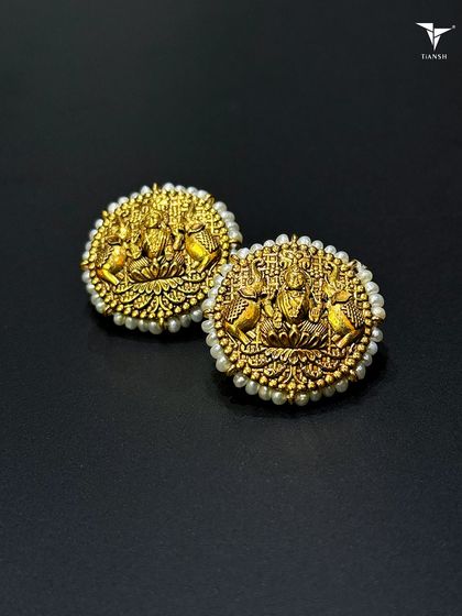 One of my most classic pieces, these 22kt gold studs feature Maa Laxmi, surrounded by a delicate border of pearls. These are the kind of earrings that can be passed through generations.