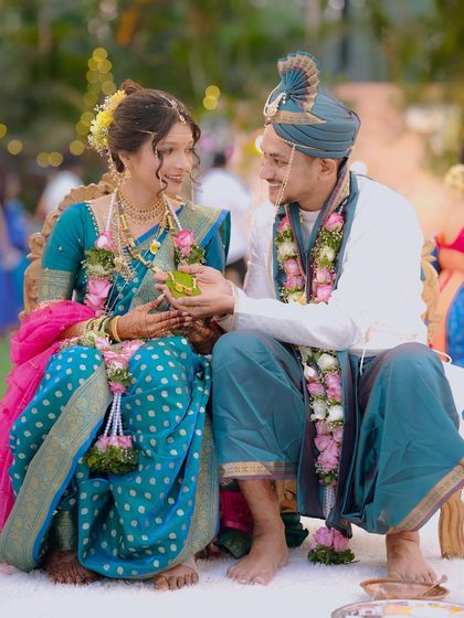 A sweet moment during the wedding ceremony. The groom offers a gift to his bride, their smiles reflecting the joy of the occasion.