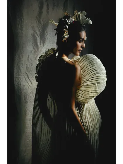 A dramatic, low-key lighting setup for the same Vaishali S. gown. By concealing parts of the garment in shadow, I create a sense of mystery and draw attention to its unique, shell-like silhouette.