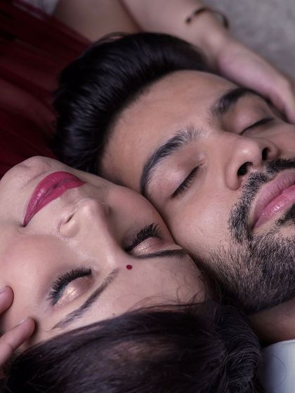 A serene and intimate close-up of an expecting couple resting together. This photo captures a moment of peace and togetherness before the baby arrives.