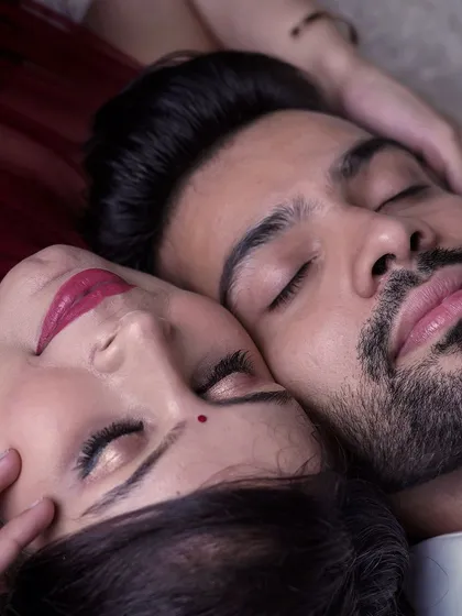 A serene and intimate close-up of an expecting couple resting together. This photo captures a moment of peace and togetherness before the baby arrives.