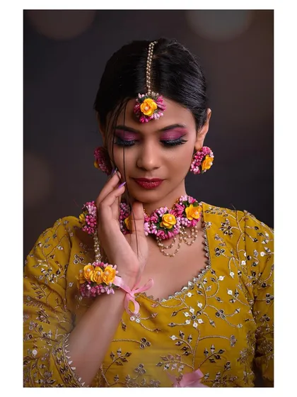 A detailed shot focusing on the floral jewelry, including the necklace, earrings, and maang tikka. This is ideal for showcasing accessory collections.