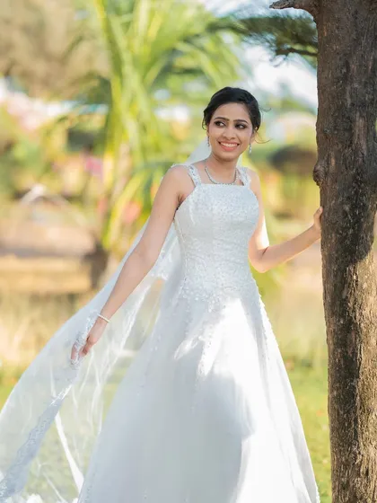 A joyful moment in the sun. The makeup is light and fresh, perfect for an outdoor photoshoot after the ceremony.