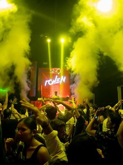 The crowd at SinQ Nightclub goes wild as yellow smoke fills the room. I love mixing colors and effects to match the vibe of the music.