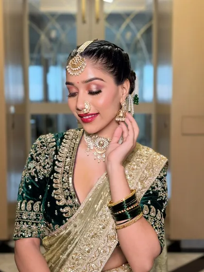 A graceful side profile, highlighting the elegant bun and the details of the jewelry. The makeup is polished and refined, completing this regal bridal look.