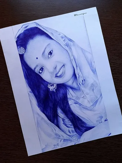 This is a finished ballpoint pen sketch of a smiling woman in traditional attire. I used a blue pen to carefully draw her dupatta and the details of her earrings, creating a classic and elegant portrait.