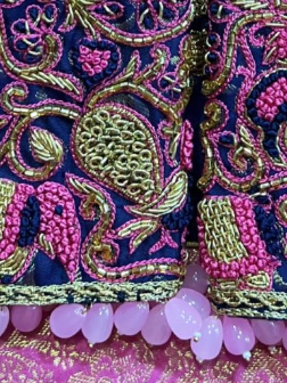 A full view of the sleeve hem with the beautiful pearl tassels. These small details complete the overall look of the custom blouse.