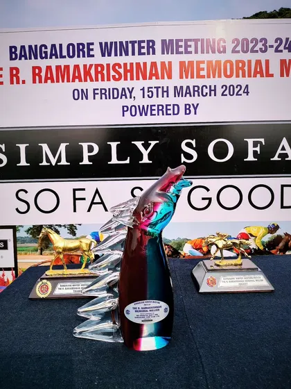 The R. Ramakrishnan Memorial Million trophy, a modern glass art piece.