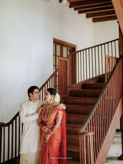 Another elegant portrait of the couple on the staircase of the heritage palace.