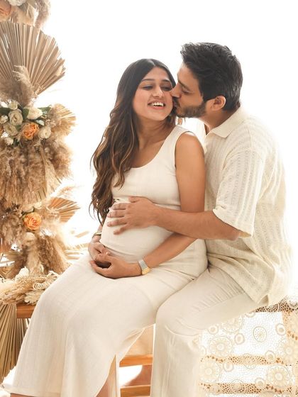 A sweet kiss on the cheek, a gesture of affection and support. This image beautifully portrays the partnership and love that are the foundation of their growing family.