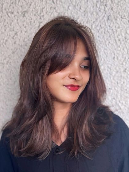 A subtle and rich brunette look with soft curtain bangs. This style is effortlessly glamorous and perfect for everyday wear.