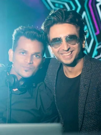 Posing with a fellow DJ collaborator. We work together to build sets that flow perfectly, ensuring the musical journey for the night is seamless and exciting.