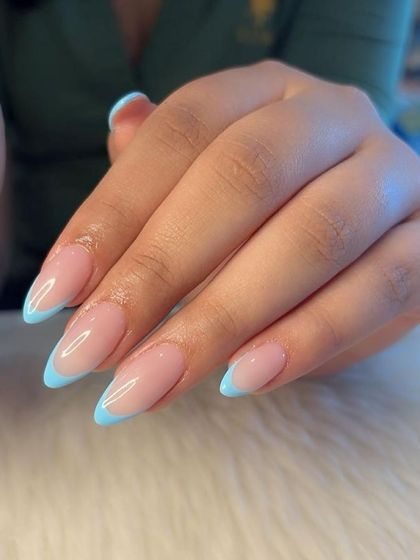 A close-up of the flawless baby blue French tips, showing the clean smile line and glossy finish.