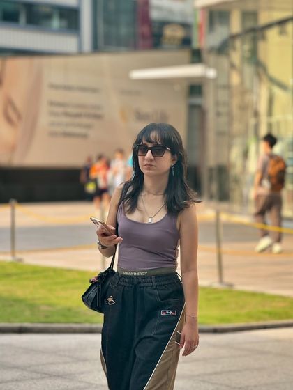 A candid street style moment featuring another pair of my custom wide-leg pants. This design incorporates a subtle logo detail on the waistband and unique paneling.