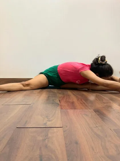 Upavistha Konasana (Wide-Angled Seated Forward Bend) is a deep forward bend that stretches the hamstrings and inner thighs. This pose calms the brain and releases tension from the groin and spine.