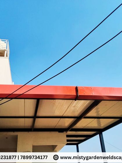 The finished puff sheet pergola with a red metal fascia, giving it a clean and modern look while ensuring durability.