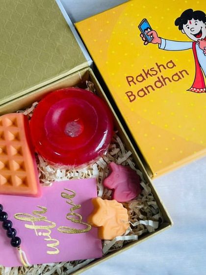 A fun Raksha Bandhan hamper designed for a little brother. This box includes a waffle soap, a donut soap, and mini unicorn soaps, along with a 'With Love' tag and rakhi.