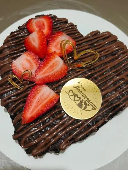 A heart-shaped brownie is my favorite way to celebrate an anniversary or Valentine's Day. This one is a rich chocolate brownie, drizzled with Nutella and topped with fresh strawberries and a custom anniversary message.